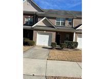 Inviting brick townhouse with attached garage and well-maintained landscaping at 2555 Flat Shoals Rd # 2006, Atlanta, GA 30349