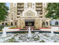 Beautiful building exterior view highlighting manicured landscaping and a grand fountain feature at 795 Hammond Dr # 813, Sandy Springs, GA 30328