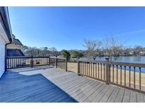 Spacious wooden deck overlooking the lake, featuring dark wood railings at 2762 Inverloch Cir, Duluth, GA 30096