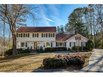 Charming two-story traditional home with a well-manicured front yard and mature landscaping at 5443 Dunwoody Knoll Ct, Dunwoody, GA 30338