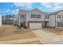 Traditional two-story home featuring a brick facade, two-car garage, and a well-manicured front lawn at 137 Centennial Ridge Dr, Acworth, GA 30102