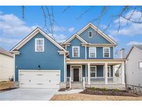 Charming blue two-story home with a welcoming front porch and manicured lawn at 9106 Hanover Street St, Lithia Springs, GA 30122