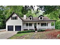 Charming two-story home features a covered porch, two-car garage, and landscaped front yard at 225 Powder Creek Dr, Dallas, GA 30157