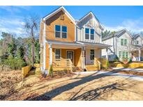 Inviting two-story duplex featuring a charming front porch and a well-maintained front yard at 1106A Wedgewood Nw Dr, Atlanta, GA 30318