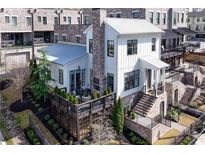 Stunning modern farmhouse featuring a metal roof, private deck and a brick and iron fence at 1311 English Nw St, Atlanta, GA 30318