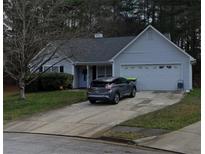 Charming single-story home with a well-manicured lawn and a two-car garage, perfect for suburban living at 637 Delay Way, Stockbridge, GA 30281