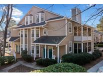 Charming condo featuring a well-maintained yard with mature landscaping, a covered porch, and a private balcony at 6420 Magnolia Way, Morrow, GA 30260