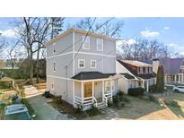 Charming two-story home featuring a covered front porch, and inviting facade at 1557 Alder Se Ct, Atlanta, GA 30317