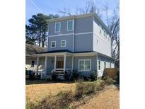 Charming two-story home with a welcoming front porch and mature landscaping at 1557 Alder Se Ct, Atlanta, GA 30317