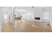 Bright living room boasts an electric fireplace, hardwood floors, and a seamless flow to the modern kitchen at 1557 Alder Se Ct, Atlanta, GA 30317