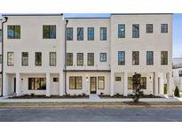 Modern townhome with white brick facade and black window frames, creating a sleek, contemporary look at 2202 Carlton Ct # 7, Atlanta, GA 30318