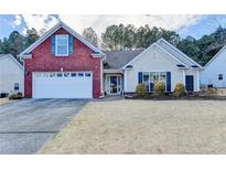 Charming single-Gathering home with a manicured front yard, a two-car garage, and classic architectural design at 2506 Creek Station Dr, Buford, GA 30519