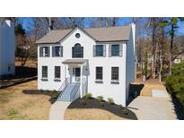 Charming two-story home with a well-manicured lawn, inviting curb appeal, and classic architectural details at 1030 Laurel Valley Sw Dr, Marietta, GA 30064