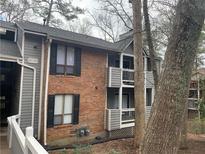 Two story brick and vinyl condo with cozy balconies and treed landscape at 330 Warm Springs Cir, Roswell, GA 30075