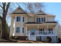 Charming two-story home with gabled roof, bay windows, and inviting front porch at 2031 Lakewood Cir, Grayson, GA 30017