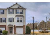 Inviting townhouse featuring a two-car garage and charming architectural details at 6798 Blackstone Pl # 12, Mableton, GA 30126