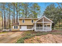Charming two-story home with stone accents, covered porch, and a well-maintained front yard at 8640 Embrey Dr, Jonesboro, GA 30236