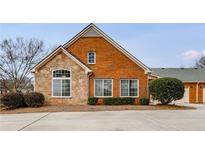 Charming brick and stone home with manicured landscaping and attached garage at 1404 Haven Cir, Douglasville, GA 30135