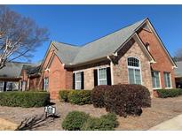 Charming brick and stone home with well-manicured landscaping and a gray shingle roof at 1404 Haven Cir, Douglasville, GA 30135