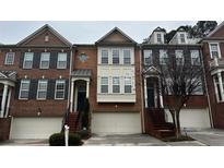 Charming townhome exterior with brick facade, attached garage, and inviting front entrance at 4621 Wehunt Commons Se Dr # 7, Smyrna, GA 30082