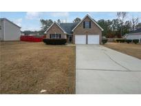 Charming two-story brick home with a two-car garage and a well-maintained front yard at 213 Ermines Way, Mcdonough, GA 30253