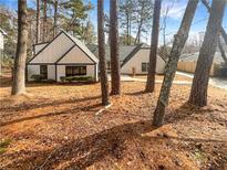 Charming single-Gathering home featuring a well-manicured lawn and mature trees, creating a serene and inviting curb appeal at 7040 Northgreen Dr, Atlanta, GA 30328