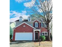 Charming two-story brick home featuring dormer windows and a two-car garage at 2011 Atkinson Park Dr, Lawrenceville, GA 30043