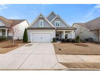 Charming two-story home with a well-maintained lawn and a two-car garage and a light blue trim at 206 William Creek Dr, Canton, GA 30115