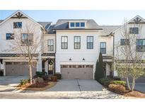 Charming two-story townhome with a two-car garage and beautifully landscaped front yard at 204 Phillips Ln, Alpharetta, GA 30009