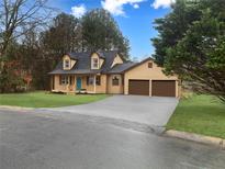 Charming two-story home with a two-car garage, a cozy front porch, and a well-manicured lawn at 5265 Springtide Ln, Powder Springs, GA 30127