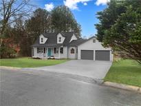 Charming home with a two-car garage, neutral siding, well-maintained lawn, and a bright blue front door at 5265 Springtide Ln, Powder Springs, GA 30127