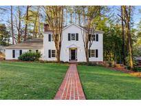 Charming two-story home boasts a well-manicured lawn and a classic brick walkway at 6350 Blackwater Trl, Sandy Springs, GA 30328
