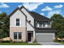 Charming two-story home with a stone and light grey siding exterior, complimented by a 2-car garage at 4435 Beechnut Cir, Cumming, GA 30028