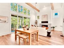 Bright living room with wooden floors, fireplace, large windows, and sliding door to an outdoor balcony at 1250 Lupo Loop, Palmetto, GA 30268