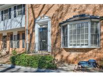 Charming brick townhome featuring a classic bay window and a welcoming front entrance with mature landscaping at 6520 Roswell Rd # 79, Sandy Springs, GA 30328