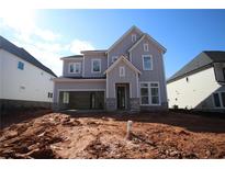 New two-story home featuring board and batten siding, open garage, and stone accents at 4780 Briscoe Dr, Cumming, GA 30028