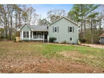 Charming single-Gathering home with a manicured front yard, a porch, and a classic architectural style at 412 Ladora Dr, Dallas, GA 30157