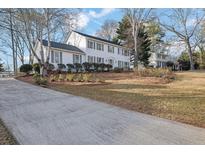Charming two-story home with white siding, gray shutters, and well-maintained landscaping at 1040 Millridge Se Ln, Marietta, GA 30067
