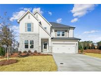 Charming two-story home with stone accents, white siding, well-manicured lawn, and inviting curb appeal at 4480 Beechnut Cir, Cumming, GA 30028