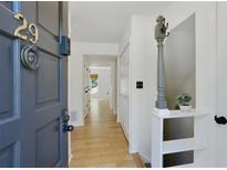 Inviting entryway featuring a wood floor, neutral walls, and a charming front door at 29 Ivy Ne Trl, Atlanta, GA 30342