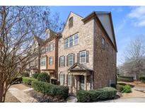 Charming brick townhome with manicured landscaping, covered entry and classic architectural details at 508 Micayne Se Cir, Smyrna, GA 30082