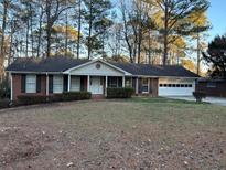 Charming single-story home with a well-maintained front yard and an attached two car garage at 2853 Umberland Dr, Doraville, GA 30340