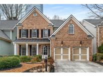 Charming brick home featuring an attached two-car garage and well-manicured landscaping in a suburban neighborhood at 3510 Preserve Se Dr, Atlanta, GA 30339