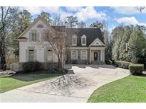 Beautiful two-story home with a well-manicured lawn and long driveway at 4565 Club Ne Dr, Atlanta, GA 30319