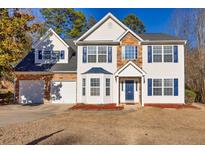 Charming two-story home features a two-car garage, beautiful stone accents and blue shutters at 2010 Skylar Leigh Dr, Buford, GA 30518