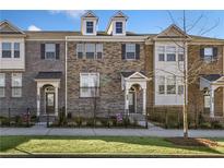 Charming townhome with brick and stone facade, small yard, and inviting entryway at 3533 Koyla Lndg # 5, Chamblee, GA 30341