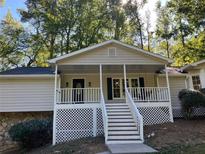 Charming home featuring a welcoming front porch, new roof, and classic design at 1320 Sherry Dr, Alpharetta, GA 30009