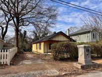 Charming yellow home with a classic design and mature trees at 18 Wyman Ne St, Atlanta, GA 30317
