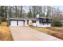 Charming exterior of a home with a two-car garage and well-maintained landscaping at 466 Thackery Sw Pl, Atlanta, GA 30311