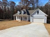 Charming single-Gathering home featuring a two-car garage, dormer windows, and a covered porch at 200 Brookwood Xing, Douglasville, GA 30134